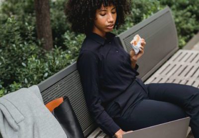 Woman sitting on a bench with laptop